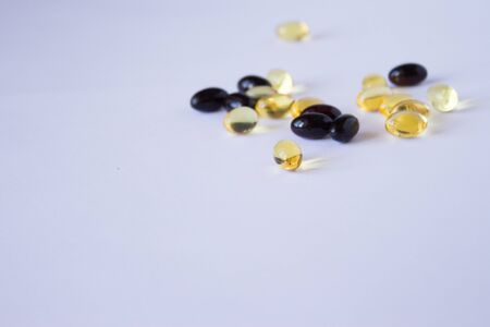 astaxanthin and fish oil. Gel capsules on white backgroundの写真素材