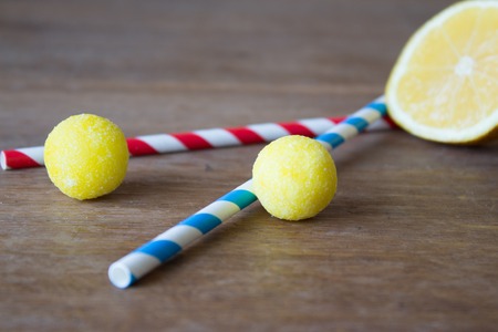Old-fashioned of lemon candy and lemon on wooden board.の写真素材