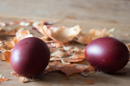 Eggs, painted with onion husks. Easter eggs and onion husks. Wooden boardの写真素材