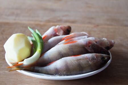 Peeled river fish for soup. Winter fishing. Wooden boardの写真素材