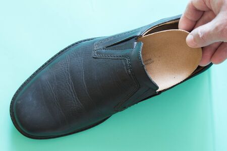 Top view of black leather shoes with orthopedic insoles. Neutral background.