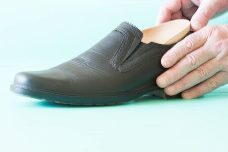 Black leather shoes with orthopedic insoles. Neutral background.