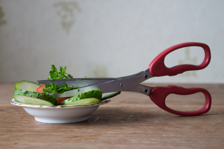 Special herb scissors with multiple blades. Green parsley cut into special scissors. wooden boardの写真素材