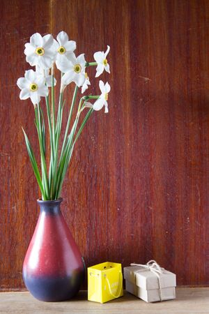 Bouquet of white daffodils in a ceramic vase. Romantic gifts. Spring Flowers. Narcissus on wooden background.の写真素材