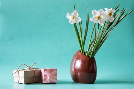 Bouquet of white daffodils in a ceramic vase. Romantic gifts. Spring Flowers. Narcissus on neutral background.の写真素材