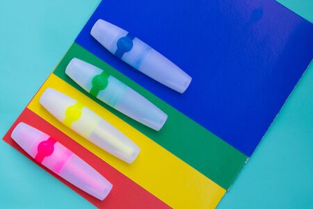 Bright colored markers or felt pen are located on sheets of colored paper.の写真素材