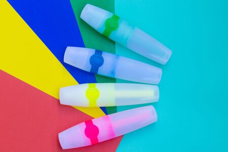 Bright colored markers or felt pen are located on sheets of colored paper.の写真素材