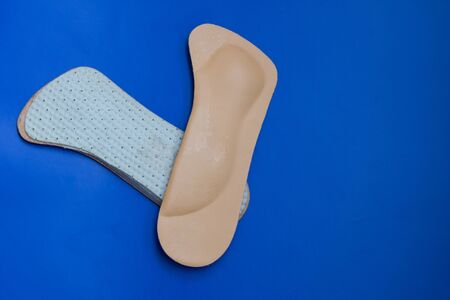 Leather orthopedic shoe insoles. Blue background.の写真素材