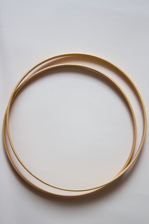Wooden hoop for embroidery on beige background. Top view.の写真素材
