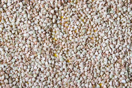 Pile of grain green buckwheat background. Top view.