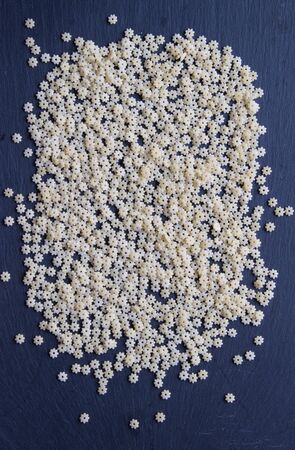 Raw pasta star shape isolated on stone background. Top view.の写真素材