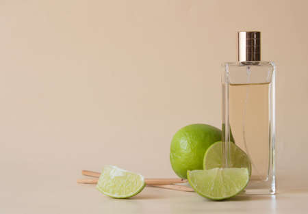 Glass cosmetic bottle spray with fresh lime slices. Using citrus for cosmetic. Health care concept.の写真素材