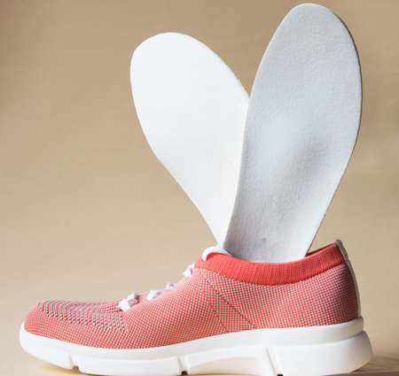Orthopedic insoles inserted into sneaker, sport shoe. Method of prevention of flat feet and foot...