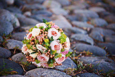 The bride's rose bouquet on the stonesの写真素材