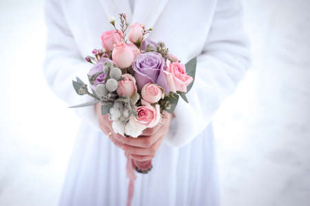 winter bouquet with large roses in purple tintの写真素材