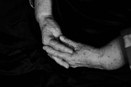 Hands with wrinkles and pigment spots old manの写真素材