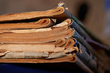 a stack of dusty old magazines lying buttの写真素材