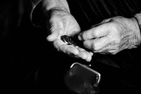 Hands of an old man counting money