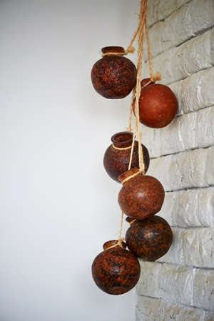 many ethnic wooden pots hanging on the ropeの写真素材