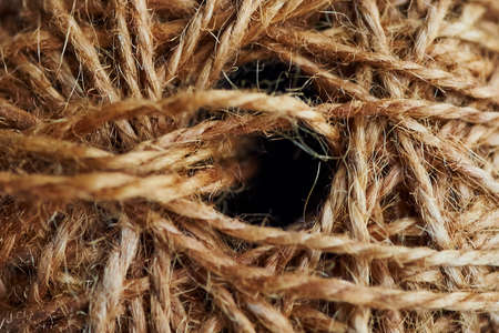A roll of natural brown rope , background