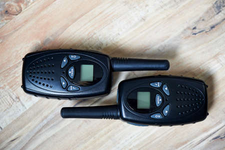 Two black compact professional portable radio sets with mapsの写真素材