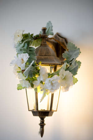 Golden sconces lantern with wreath. Warm and cozy lightの写真素材