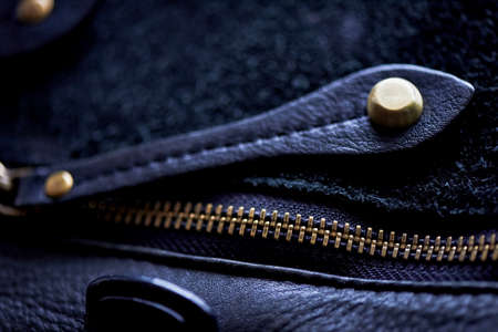 ajar the zipper on a black leather bag