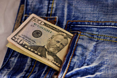 american dollar bills in jeans pocket backgroundの写真素材