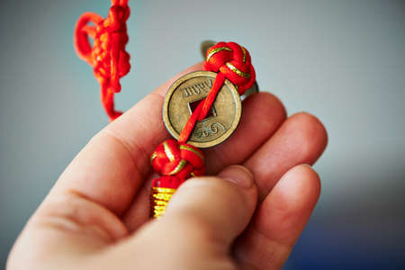 Closeup of Antique Chinese coins in his handの写真素材