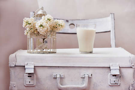 A glass of milk and bowl of insipidity. White background on the suitcaseの写真素材