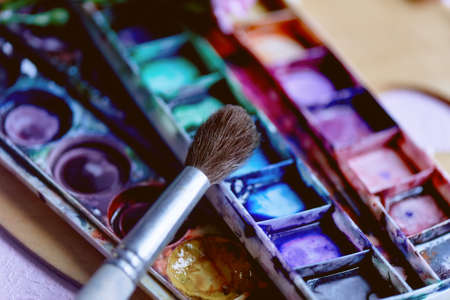 The workplace of the artist. Paint brush and pink carnations Still life composition of artistic workplaceの写真素材