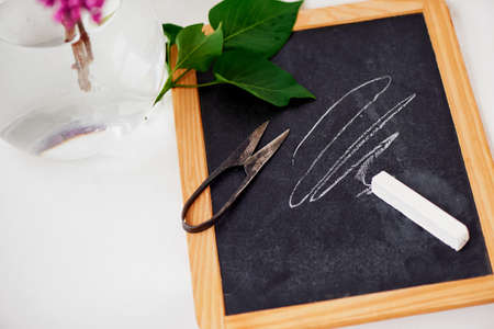 Blackboard with white chalk and vintage scissorsの写真素材