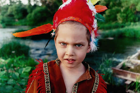 a little boy in a red suit Indian looks in the frame a bold look. Close portraitの写真素材