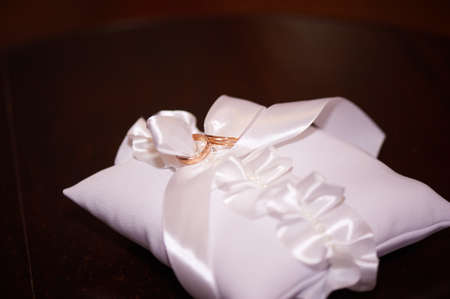 bridal wedding rings on a white pillowの写真素材