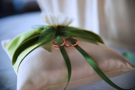 bridal wedding rings on a white pillowの写真素材