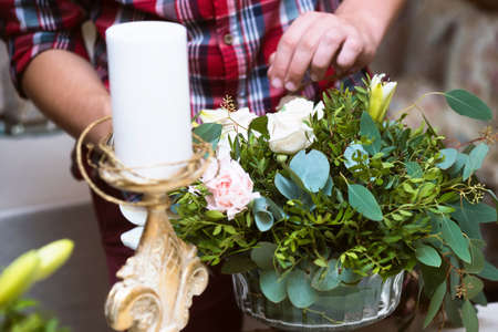 The decor for the wedding photo shoot. Wedding arrangement on the table and hands floristの写真素材