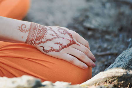 Hand yoga with brown henna mehendi. Harmony and tranquilityの写真素材