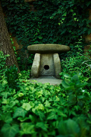 A small figure of a dolmen in the green thickets. Symbolの写真素材