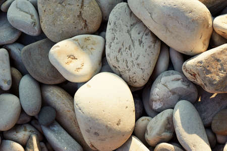 The texture of sea pebbles. Light stones to the sea, closeの写真素材