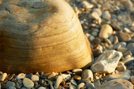Wet sea stones lying on the beach. Close
