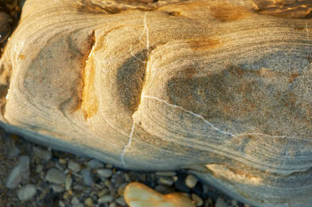 Wet sea stones lying on the beach. Close