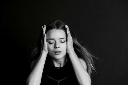 Young girl holding whiskey as headaches. BWの写真素材