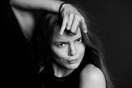 Young beautiful girl. Sign rock n roll fingers. Naughtyの写真素材