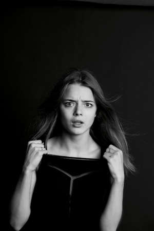 Young beautiful girl builds faces. Hamming , fun