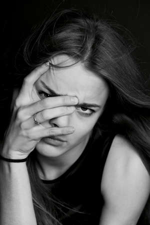 Young beautiful girl builds faces. Hamming , fun