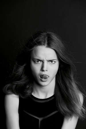 A young girl with long hair. Daring look in . BWの写真素材
