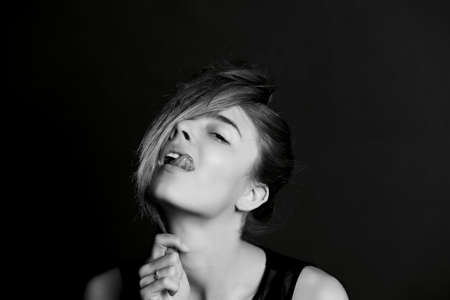 Young beautiful girl the hair on the eyes. BW