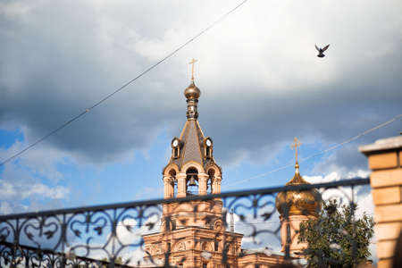 Russia, Zhukovsky, August 29, 2014: dome of the Church in the city centre. Flies the dove, a bright blue sky with grey clouds. The wrath of heavenの写真素材