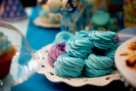 Sweet table for childrens birthday party in turquoise and purple. A sense of celebration, of joy. Beautiful sweetsの写真素材