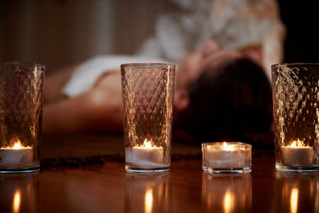 In the foreground candles, in the background the massage. Hardwood floors. state of relaxationの写真素材